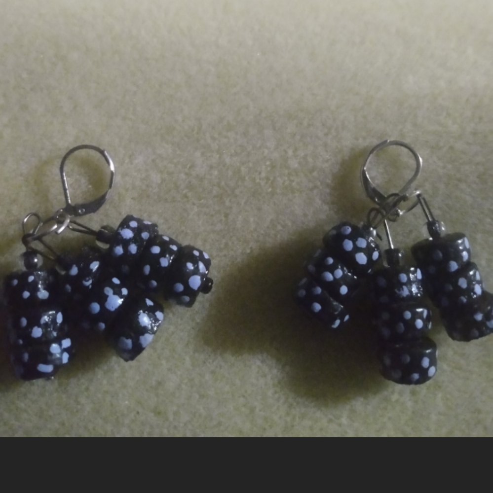 Black cillender beads with blue dots on a lever back ear wire
